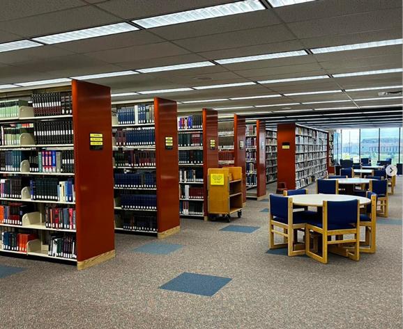 Photo of the library with shelves and tables